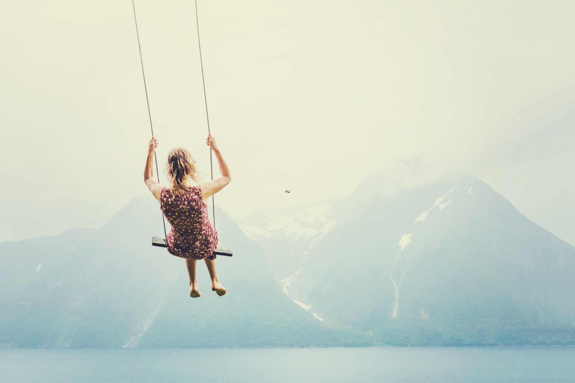 Girl swinging over a lake image from Canva